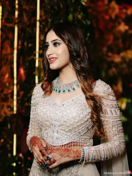 A close-up of this stunning party guest. The makeup features a defined smokey eye and contoured cheeks, creating a look that is pure elegance.