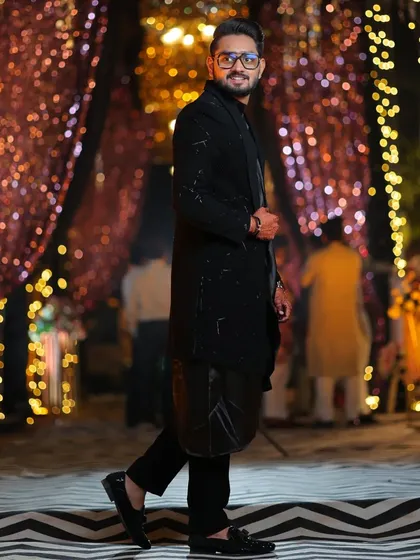 This is my open-style black Indo-western. I used a combination of salli pipe and katdana beadwork for texture, layered over a flowing koul kurta for a modern reception look.