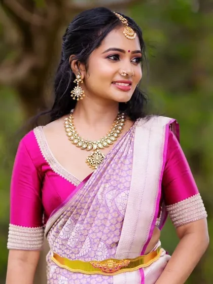 A client in a lavender and pink Kanchipuram saree. Her custom pink blouse is simple and elegant, allowing the beautiful colors of the saree to shine.