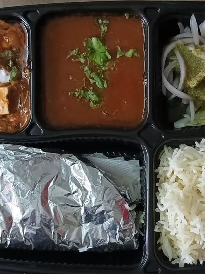A rich thali with shahi paneer and rajma. This is a perfect meal for a special occasion or when you are in the mood for something indulgent.