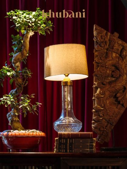 Every corner tells a story. This carefully curated nook, with its bonsai tree, classic books, and elegant lamp, reflects our belief that every meal deserves a beautiful, thoughtful setting.
