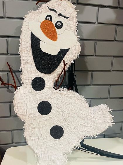 Do you want to build a snowman? This Olaf piñata is sure to bring warm hugs and lots of fun to any Frozen-themed party. His cheerful smile and glittery details are all handmade with love.
