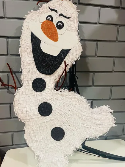 Do you want to build a snowman? How about a snowman piñata! This Olaf was a cheerful addition to a 'Frozen' themed celebration, ready to be filled with warm hugs and lots of candy.