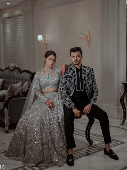 A powerful and stylish portrait of the couple in their coordinated silver and black Sangeet outfits.