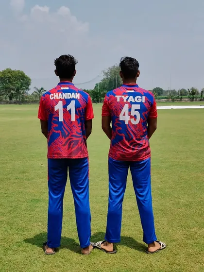 A view from the back, showing their team jerseys. Chandan and Tyagi, a formidable pair.