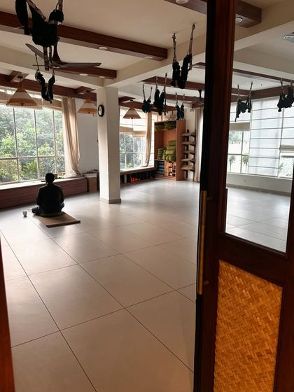 A lone yogi meditates in the quiet, empty studio. This image captures the peace and solitude that can be found within our walls, even amidst a bustling city.