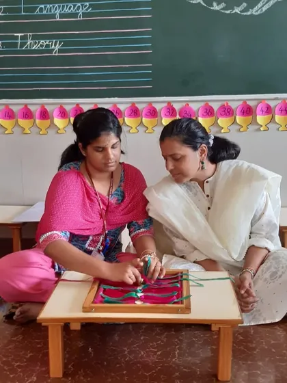 A teacher-in-training at Senthil Public School practices with the dressing frames, a key practical life material for developing independence and fine motor skills.