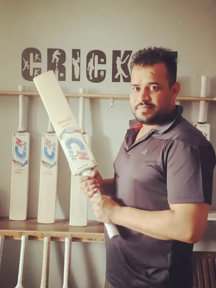 A happy customer holding his new CN CRIC bat at our store. It's important to feel the bat in your hands, and we help players find the perfect match.