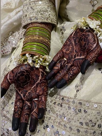The intricate patterns on the bride's palms, with a beautiful dark stain.