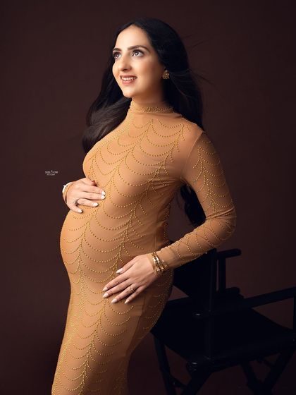 A warm, gentle portrait against a brown backdrop. I'll teach you how to use different colored backgrounds to complement skin tones and outfits.