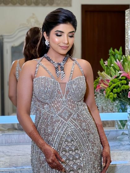 A beautiful shot of the bride looking down, highlighting the soft smokey eye and flawless lash application.