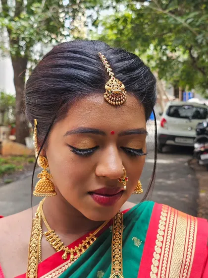 This is the radiant look we created for Prakruthi's baby shower. We used warm, golden tones on the eyes and a classic red lip to match her traditional South Indian saree.