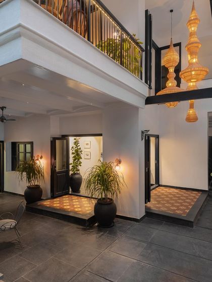 The double-height space in Maya, a restaurant in Bangalore, featuring dramatic bamboo pendant lights. I use natural materials like bamboo and cane to add elegance and a touch of sustainability to my designs.