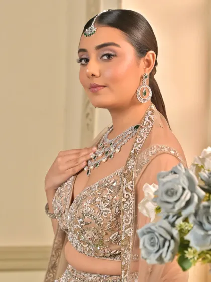 This side profile highlights the flawless base and the subtle contouring that defines her features. The look exudes grace and opulence, perfect for a sangeet night.