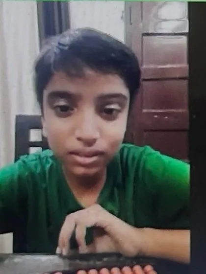 A close-up of a student, Aadi, focused on his abacus during an online class. Our virtual sessions are just as engaging and effective as our in-person classes.