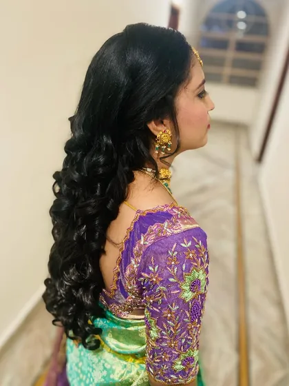 A side view of beautiful, long reception curls, showing their bounce and shine.