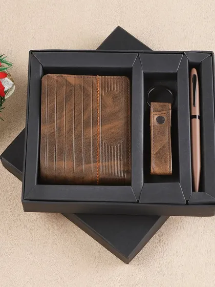 We photograph gift sets to highlight their quality and contents. This shot of a men's gift set with a wallet, keychain, and pen in a black box is tailored for e-commerce listings and promotional materials.