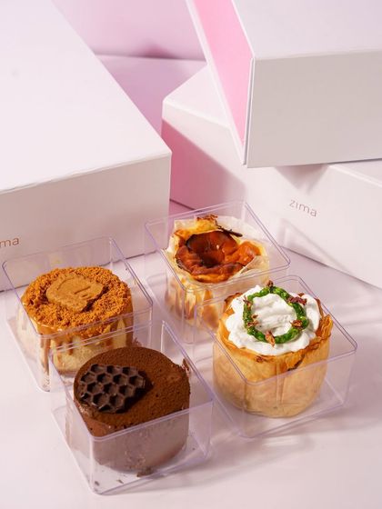 These mini dessert boxes from Zima Gourmet are shot with a clean, minimalist aesthetic. The focus is on the beautiful packaging and the variety of treats inside, making it an ideal image for a gifting catalog or e commerce site.