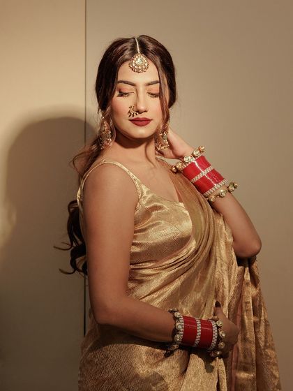 A close-up of my Karwa Chauth makeup. A classic golden saree with a red lip and my bridal 'chura' is a combination I love.
