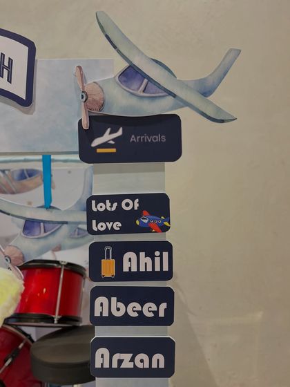 Personalization is key. This detail shot shows the 'Arrivals' sign with names of loved ones, making the gift a collective expression of love.