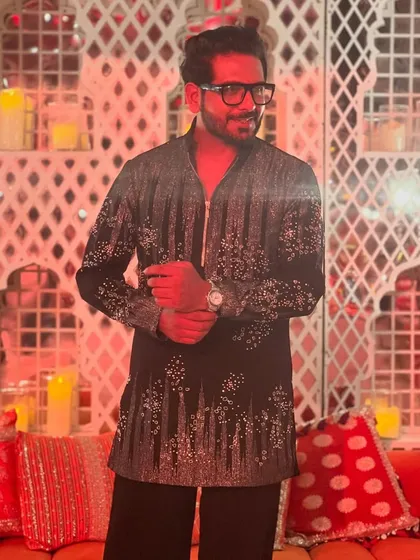A quiet moment amidst the beautiful red and gold decor of a grand Diwali celebration. The ambiance was just as warm and inviting as the company.