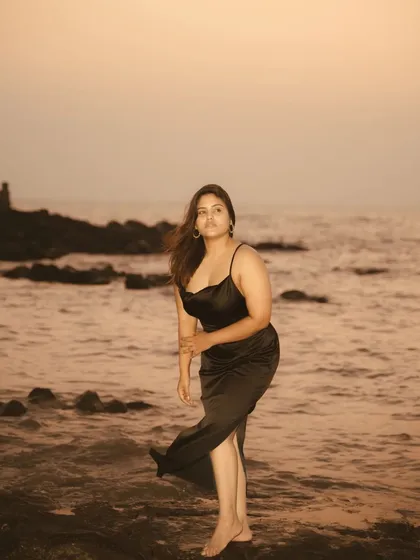 Another angle from the same sunset beach session, showing how a change in pose can alter the mood. This shot feels more contemplative, with the subject looking out towards the sea.