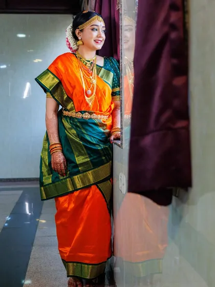 This is the traditional Iyengar Madisar, a nine-yard saree drape that is rich in cultural significance. I am an expert in creating this intricate style, ensuring it is draped authentically and comfortably for important ceremonies.