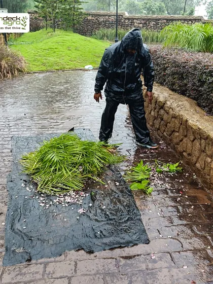 Even in the pouring rain, our commitment to garden maintenance doesn't stop. Here, our team cleans up fallen leaves and debris at a large property for the Pinnacle Group.