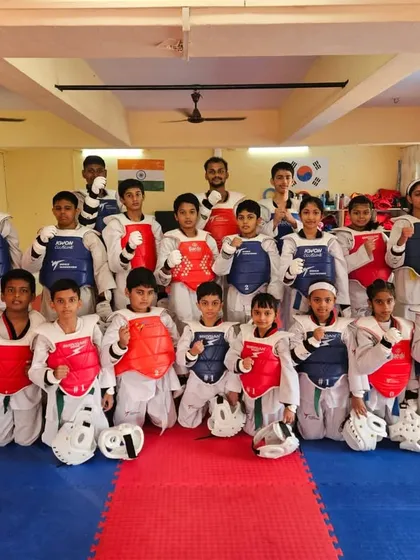 Meet the team. Our students are geared up in their protective equipment, ready for a sparring session. We foster a strong sense of community and teamwork in every class.