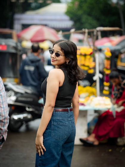 A stylish shot with sunglasses and a confident glance. This photo has a cool, editorial feel, captured right on the street.