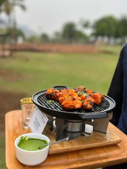 Live cooking brings energy and excitement to any event. Here, my team grills spicy paneer tikka at an outdoor celebration, serving it hot with fresh mint chutney.