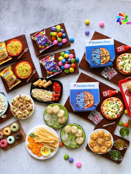 A fun collection of fast food and snack miniatures, including Maggi, pizza, momos, and Gems.