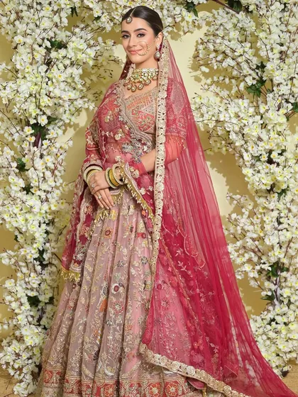 A full-length shot showing the bride's stunning lehenga and how the simple, elegant hair and makeup complement the intricate outfit.