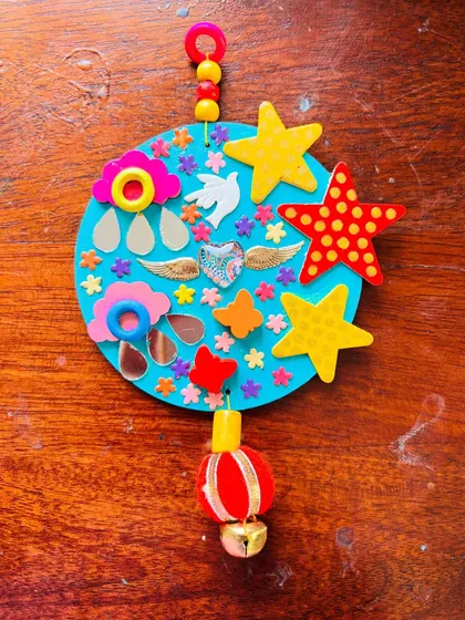 The "Our Angels" hanging laid flat, showing all its beautiful, symbolic components like the clouds, stars, and dove.