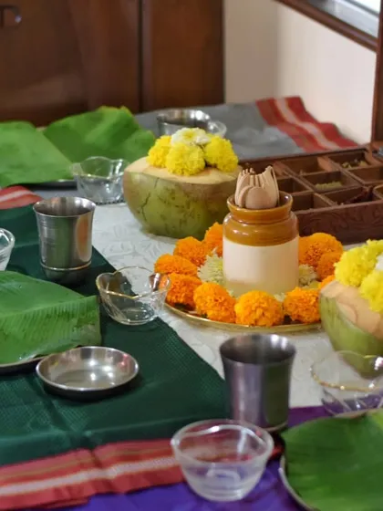 My home dining table, all set for guests. I use traditional elements like Paithani sarees, banana leaves, and marigolds to create an authentic Maharashtrian atmosphere.