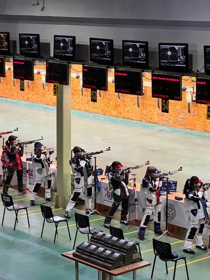 Athletes in the midst of the 10M Air Rifle Women's qualification. The atmosphere is one of intense concentration, a testament to the high level of competition we host.