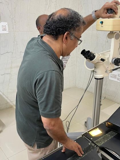 Another angle of the microscope repair, showcasing the careful, detailed work involved in fixing such a specialized piece of medical equipment.