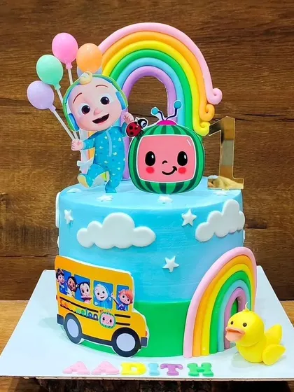A bright and cheerful Cocomelon cake. This design includes JJ, the watermelon, a rainbow, and the yellow school bus, capturing all the fun elements of the show.