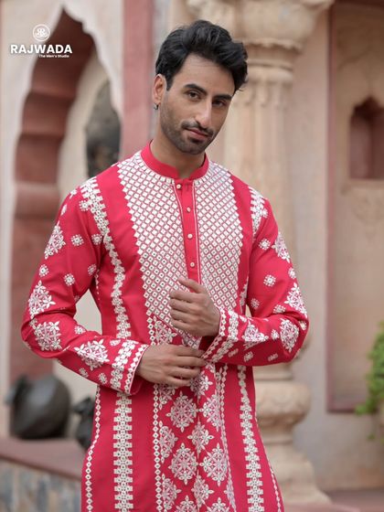 A portrait of the model in the red kurta, exuding confidence and style. The Riwayat collection is designed to make you feel your best at every event.