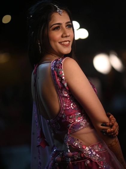 A back view of this guest's beautiful outfit, showing how the hairstyle and makeup work together to create a complete, polished look.