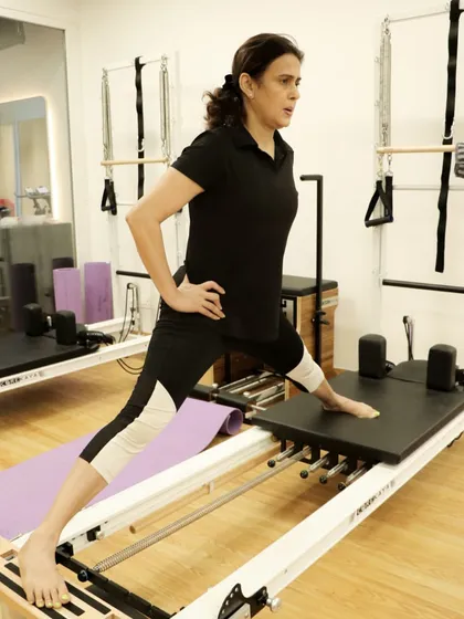 This client performs a side lunge on the reformer, a great exercise for targeting the inner thighs and improving hip mobility.
