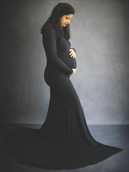 A solo portrait is all about celebrating the incredible journey of motherhood. We use simple, elegant posing and lighting to create a timeless silhouette that beautifully highlights the baby bump, capturing the miracle of growth in a single frame.
