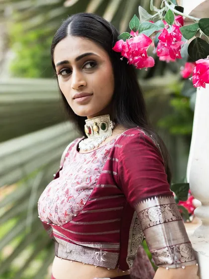 A portrait showcasing our Brick Maroon Mangalagiri silk lehenga. The printed georgette dupatta and custom blouse create a look of regal elegance.