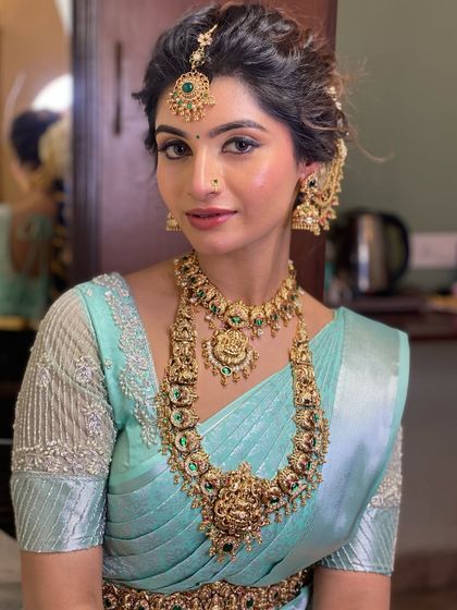 Draping for Swathi Naidu in a beautiful pastel blue saree. This look is perfect for a special occasion or function, with a soft drape that complements her elegant jewellery.