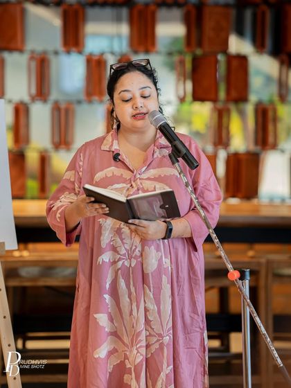 A poet reads from her journal, sharing an intimate story related to the theme. These moments of vulnerability are what make our community so strong.