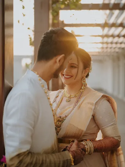 Backlit by the golden hour sun, this close-up captures the pure joy and affection between the couple. Her beautiful smile and the soft focus create a dreamy, romantic portrait that feels warm and timeless.
