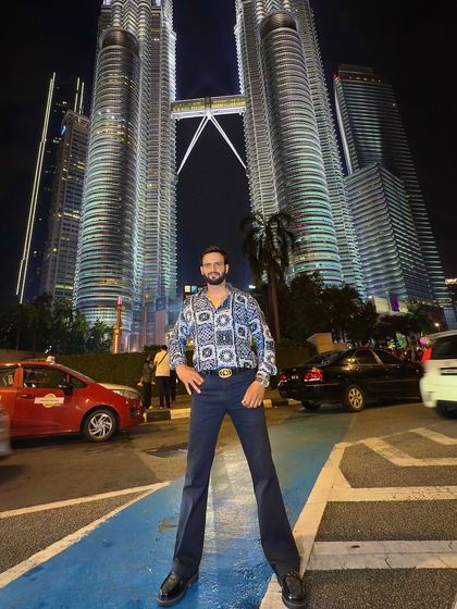 Posing before the Petronas Towers, our client showcases how our bespoke casual wear is perfect for the world traveler.