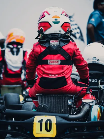 The calm before the storm. A young Micro category driver, focused and ready in his kart, embodying the fighting spirit and determination we nurture from the very first lap.