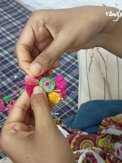 Our eco-friendly Rakhis are meticulously handcrafted using Soof embroidery, a traditional craft of Rajasthan. Here you can see the tiny, detailed stitches and embellishments like mirrors and tassels being added.