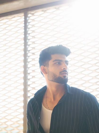 This high-key shot uses a bright, backlit background to create a soft and airy mood. It contrasts with the more industrial shots in the series, showing the model's range.